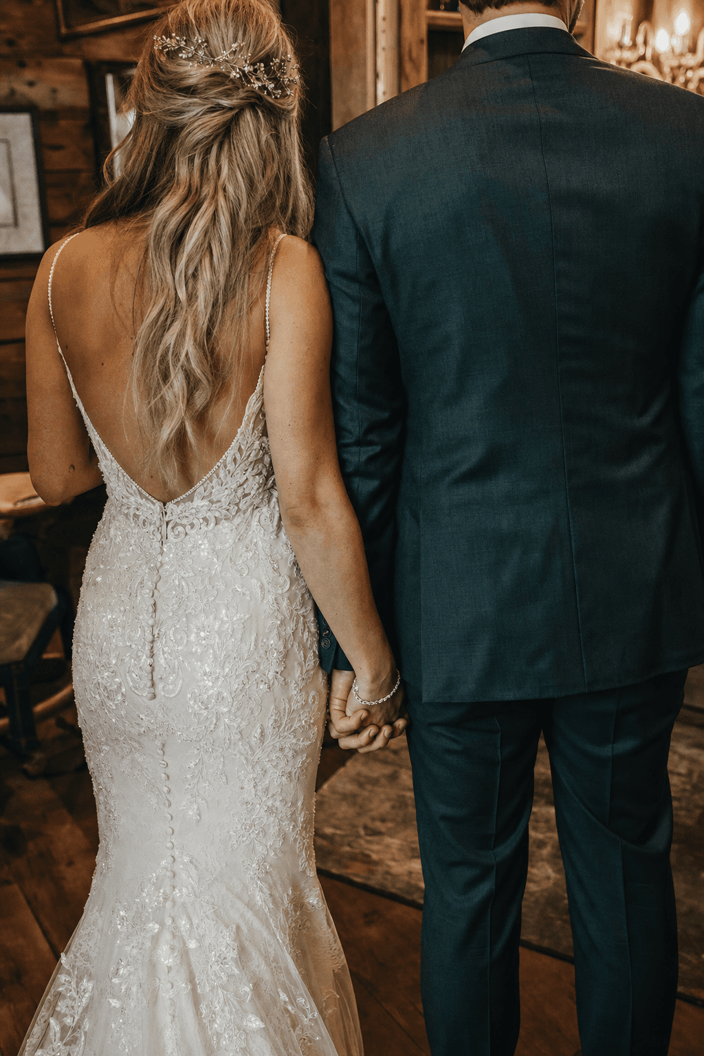 Couple holding hands before a mountain backdrop